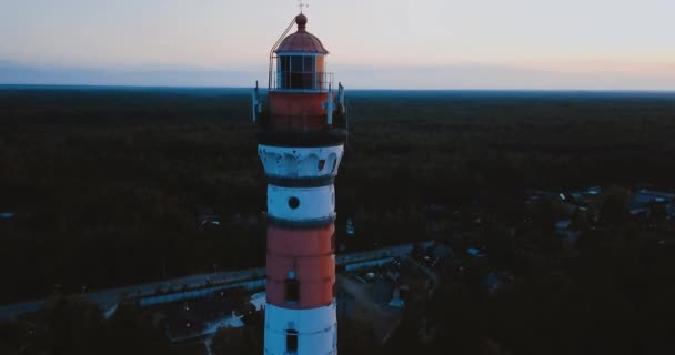 Old active lighthouse. Gloomy sky and cold blue atmosphere. Beach, north misty sea in vintage Scandinavian style. Osinovetsky Light. Lake Ladoga in Leningrad Oblast. Aerial view of seascape. 4K flying — Stock Video