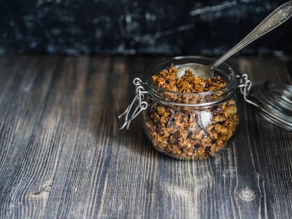 Open glass jar with homemade granola — Stock Photo, Image