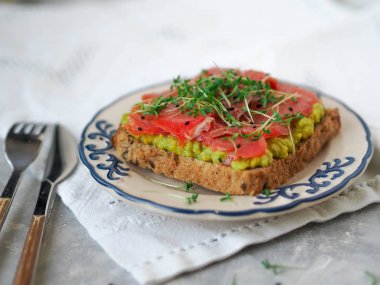 Avokado ve somon füme, ev yapımı tost tere ve siyah susam serpilir 