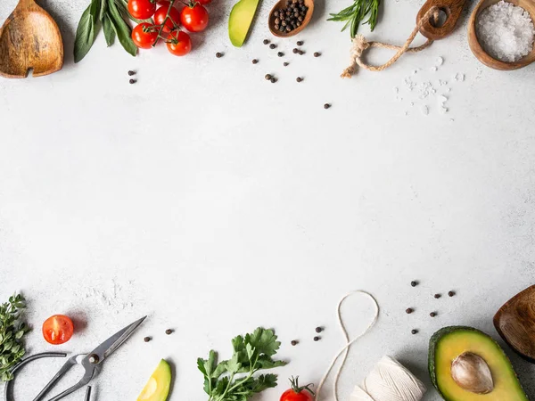 Fresh raw greens, vegetables, spices and kitchenwere frame on grey background. top view, — Stock Photo, Image