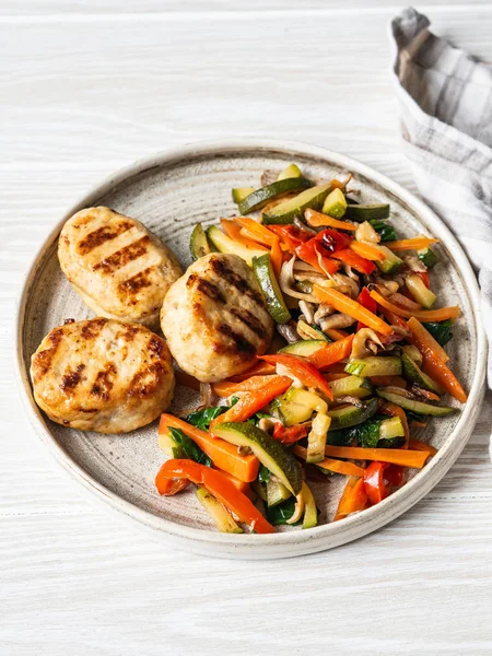 Turkey cutlets grill, vegetables steer fry on a plate on wood board table. — 스톡 사진