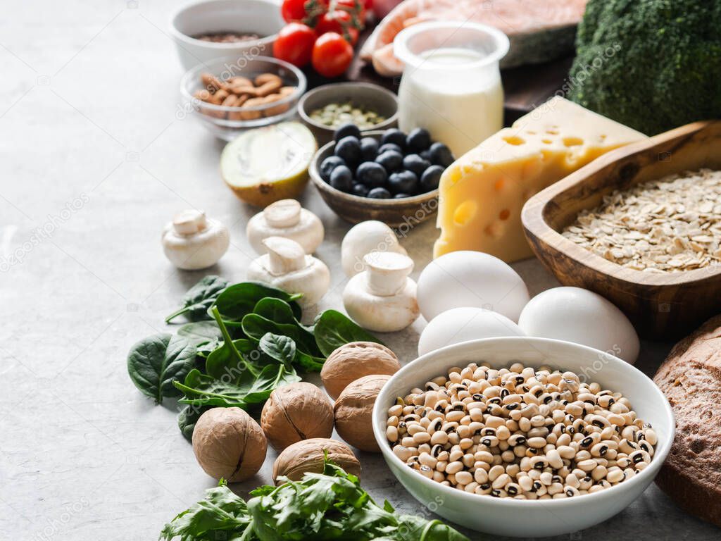 Healthy raw clean ingredients - fruits, vegetables, dairy products, eggs, legumes, dietary meat and fish, nuts and seeds on the table. Copy space. Balanced healthy food concept