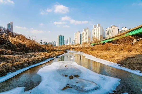 Icy river with buildings Stock Photo