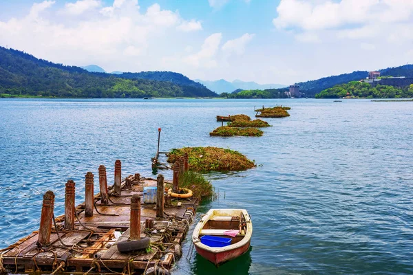 Boat and wooden raft with lake view