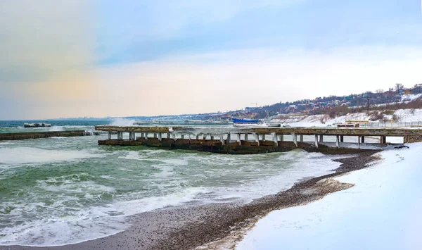 Winter seascape. Stormy waves, ice and snow at the beach at Black sea coast. March 02, 2018. Odessa, Ukraine