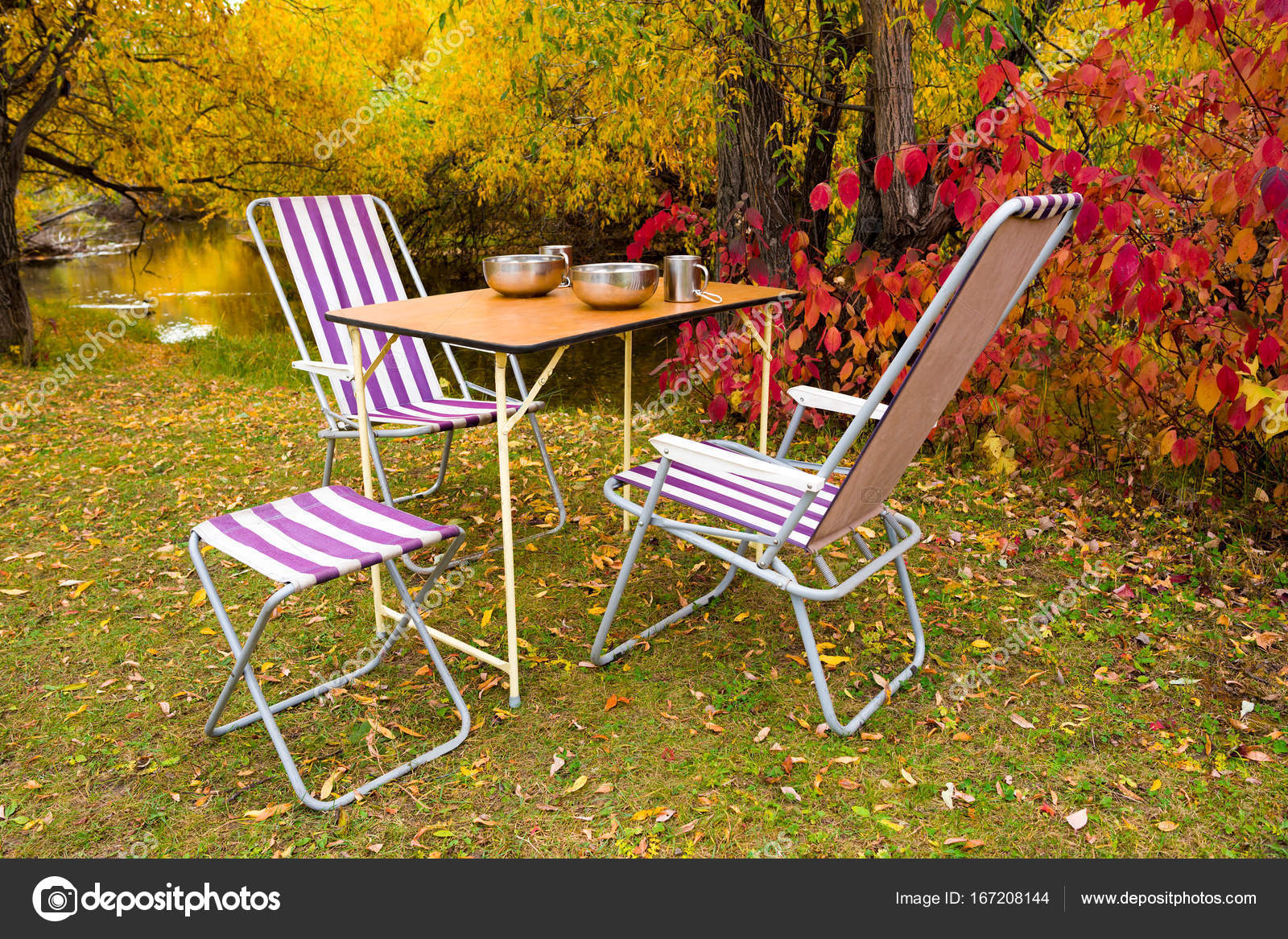 camping table and chairs in the autumn forest 167208144