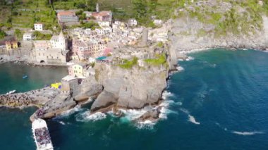 Uçurumlardaki köyün insansız hava aracı görüntüsü. Cinque Terre, İtalya 'daki eski güzel Vernazza kasabası. Güneşli bir gün ve Akdeniz. 4K
