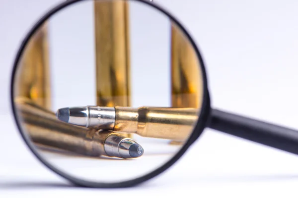 Ammunition on a white background. View through a magnifier. Isolated. Close up. Weapons. Bullets — Stock Photo, Image