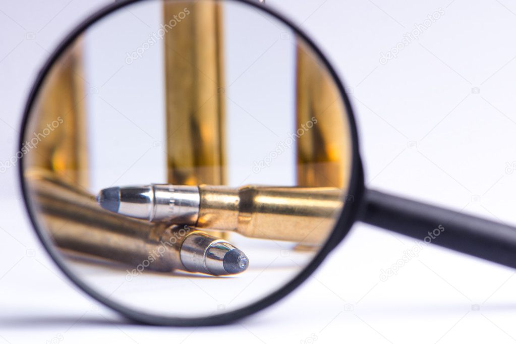 Ammunition on a white background. View through a magnifier. Isolated. Close up. Weapons. Bullets 
