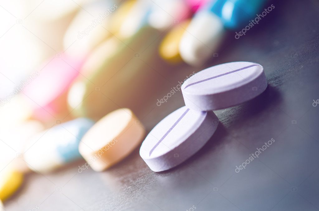 Pharmacy background on a black table. Tablets on a black background. Pills. Medicine and healthy. Close up of capsules. Differend kind of pills.