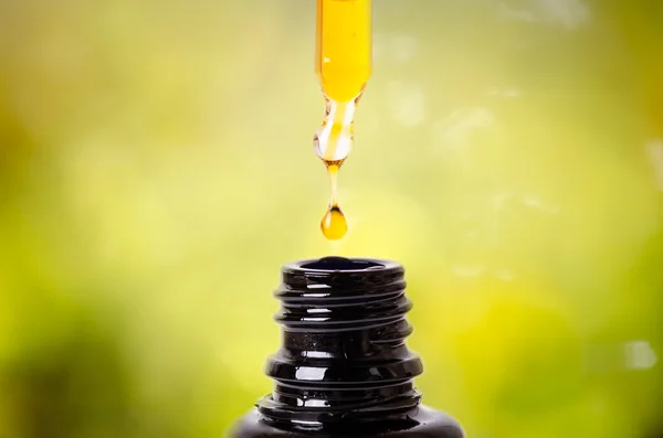 Bir damlalık şişe bir damla. Beyaz bir arka plan üzerinde izole. Eczane ve sağlıklı arka plan. Tıp. . Kadının el tutmak bir damlalık 