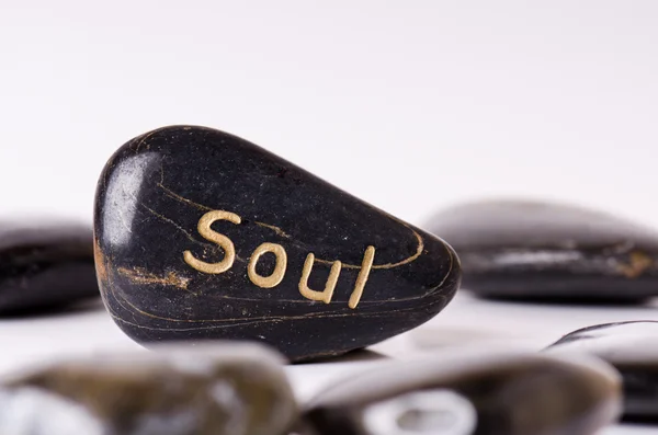 Stone treatment. Black massaging stones isolated on a white background. Hot stones. Balance. Zen like concepts. Basalt stones.