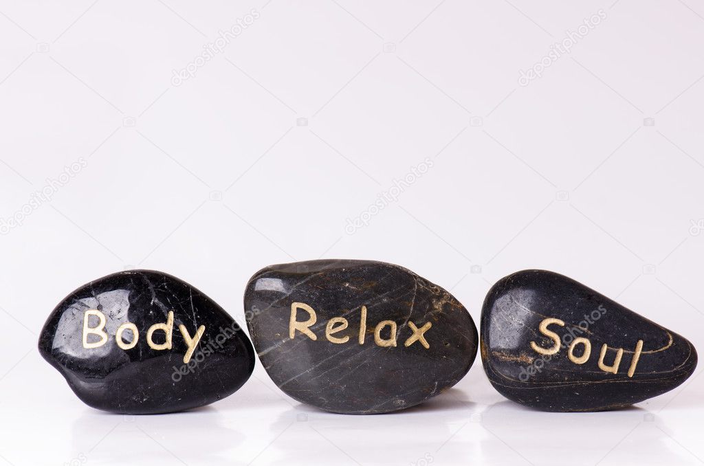 Stone treatment. Black massaging stones isolated on a white background. Hot stones. Balance. Zen like concepts. Basalt stones. 