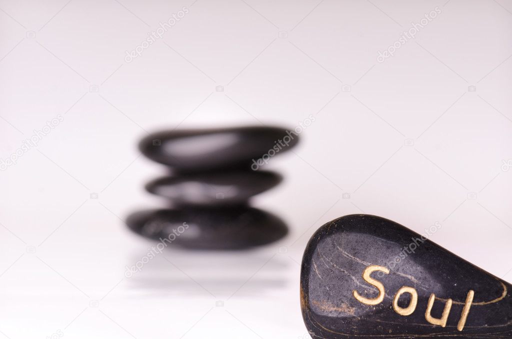 Stone treatment. Black massaging stones isolated on a white background. Hot stones. Balance. Zen like concepts. Basalt stones. 
