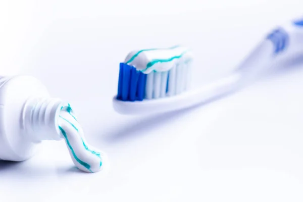 Toothbrush isolated on a white background with reflection and toothpaste. Blue plastic toothbrush. Concept of dental medicine. — Stock Photo, Image