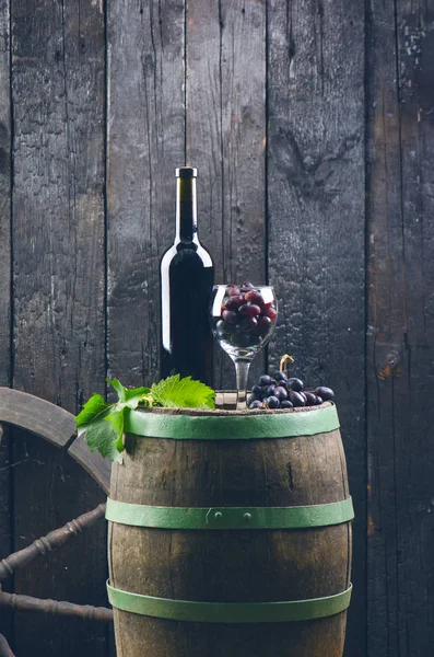 Glass Bottle Wine Next Wooden Barrel Burnt Black Wooden Background — ストック写真