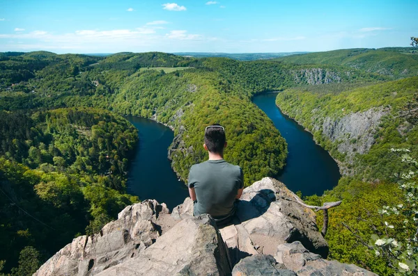 Person sitting on a peak and relaxing. Nature of Czech Republic and sightseeing called Vyhldka Mj. Vltava river.