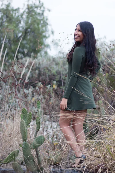 Young latina woman enjoying a walk in the wild