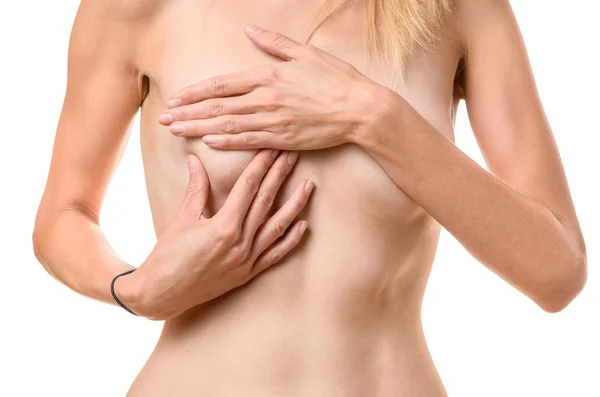 Schlanke junge Frau prüft ihre Brust — Stockfoto