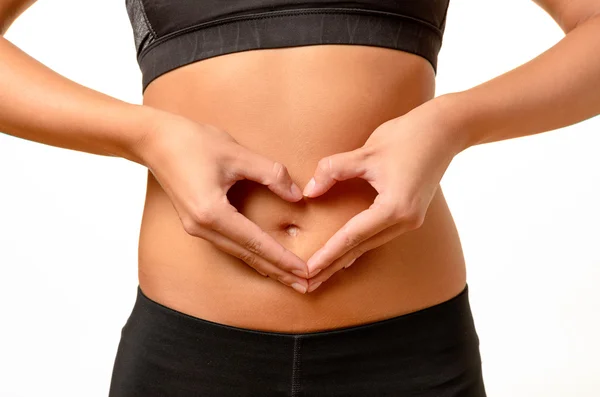 Young woman making a heart gesture — Stock Photo, Image