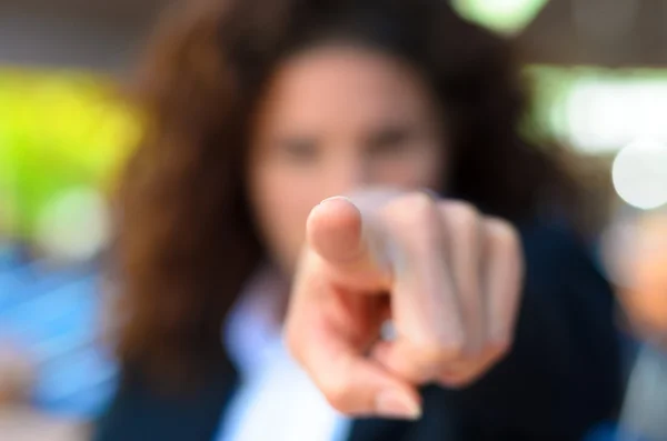 Woman pointing an accusatory finger at the camera — Stock fotografie