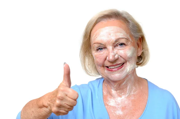 Smiling happy elderly woman wearing a face mask — Stock Photo, Image