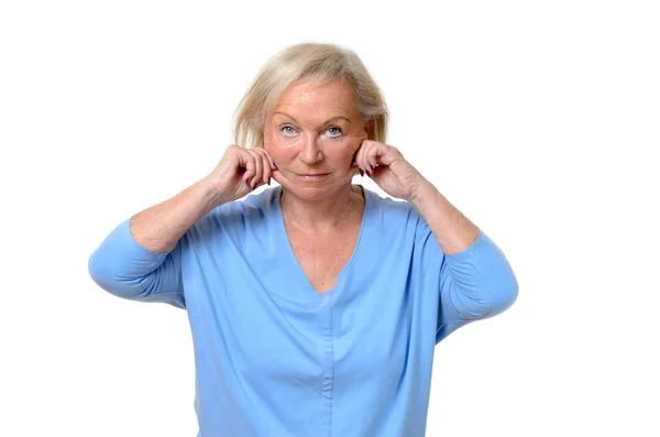 Elderly woman pulling at the skin on her jowls — Stock Photo, Image