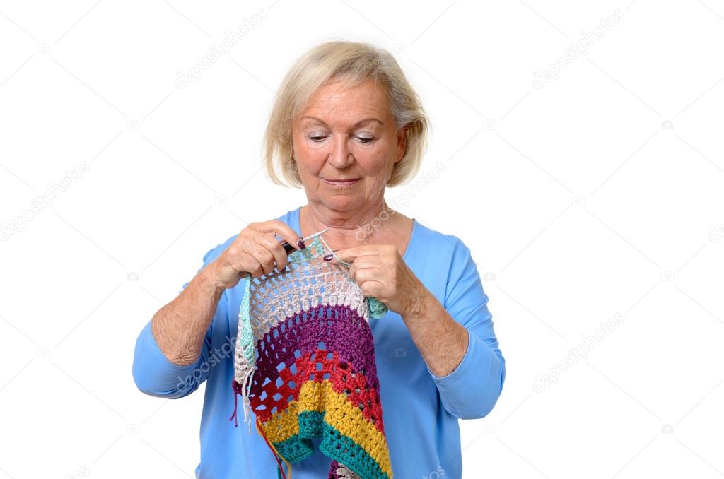 Attractive blond senior lady doing her knitting