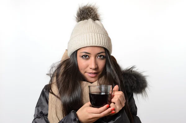 Attractive brunette enjoying a mug of hot tea — Stock Photo, Image