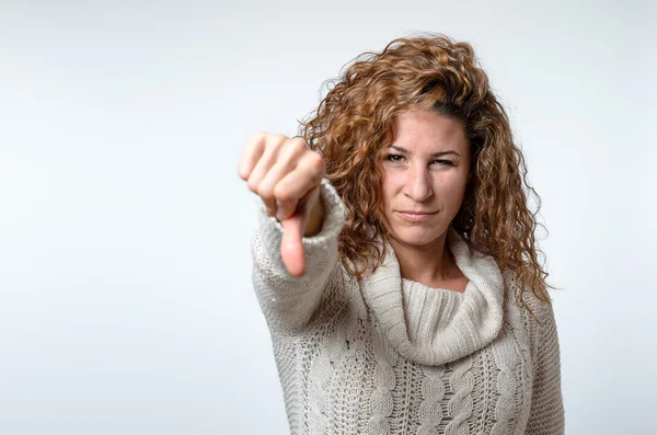 Young woman giving a thumb down gesture — Stock Photo, Image