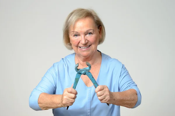 Enthusiastic elderly woman with a pliers — Stock Photo, Image