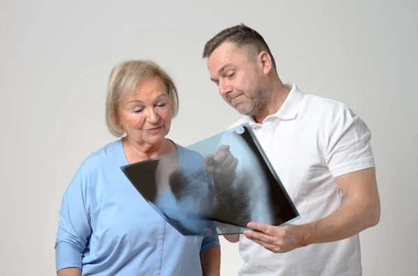 Doctor discussing an x-ray with a patient — Stock Photo, Image