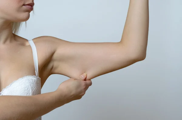 Young woman displaying the loose skin — Stock Photo, Image