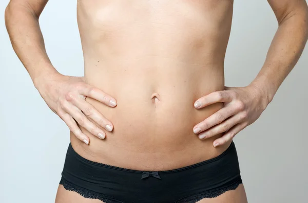 Flat Belly of a Bare middle-aged Slender Woman