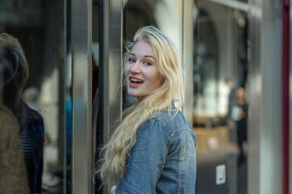 Young blond student is going into a tram — Stock Fotó