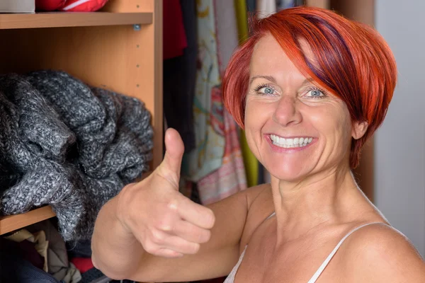 Happy Middle Aged Woman in front of her wardrobe — Stock Photo, Image