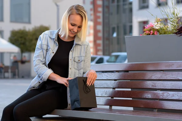 Young woman checking her purchases or gift — Stock Fotó