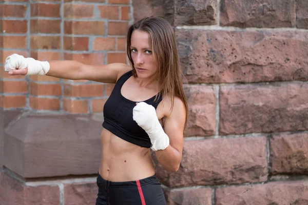 Young female boxer working out