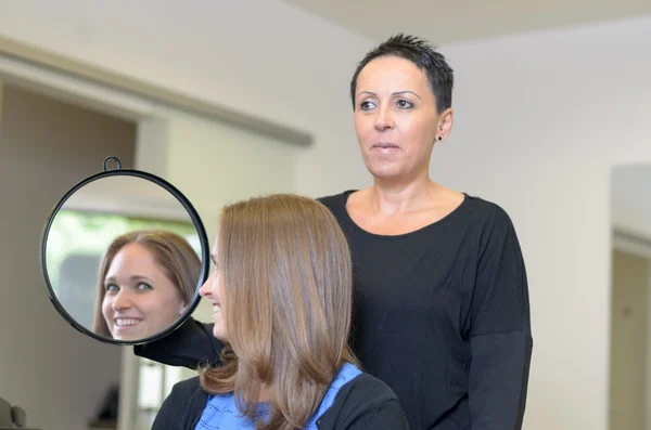 Girl Looking at Herself on Hairdresser's Mirror