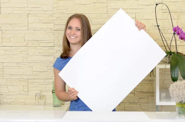 Pretty woman holding up a blank white sign