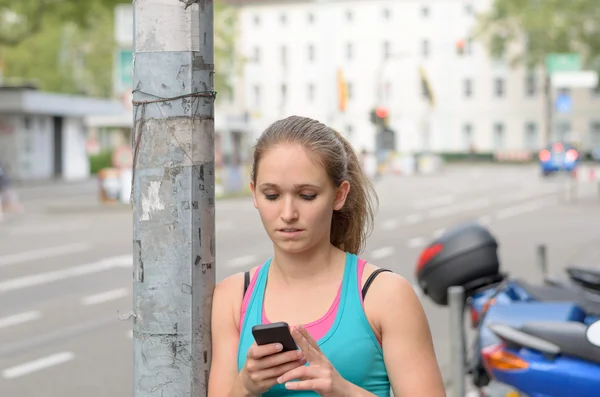 Young woman texting on her mobile phone