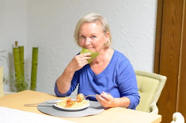 Senior woman eating a meal — Stock Photo, Image