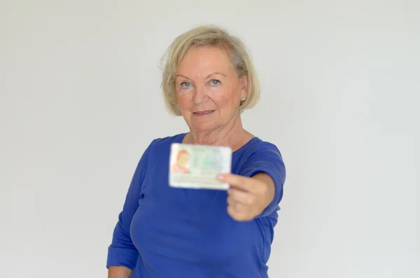 Senior lady holding out her business card — Stock Photo, Image