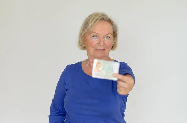 Senior lady holding out her business card — Stock Photo, Image
