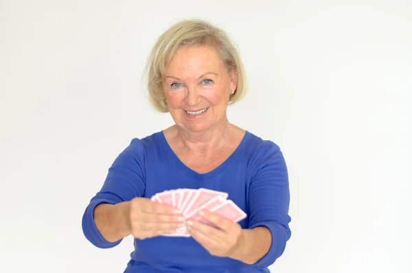 Smiling woman holding a hand of playing cards — Stock Photo, Image