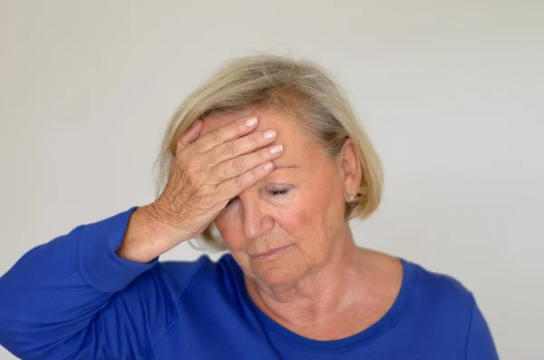 Senior lady suffering with a headache — Stock Photo, Image