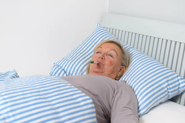 Sick Woman Lying on Bed with Thermometer in Mouth — Stock Photo, Image