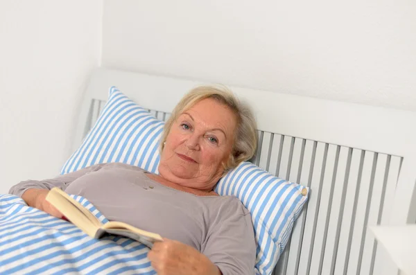 Adult Woman with Book Lying on Bed