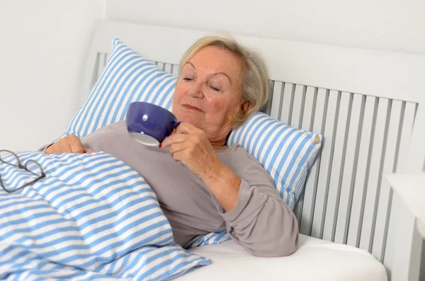 Adult Blond Woman on her Bed Holding her Cup — Stock Photo, Image