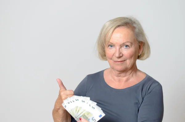 Senior Woman Holding Fan of Euros with Thumbs Up — Stock Photo, Image